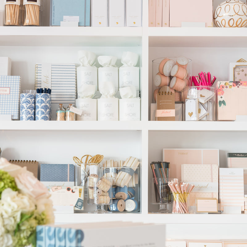 Close up of styled merchandise in shelves in the store featuring hues of blue and pink