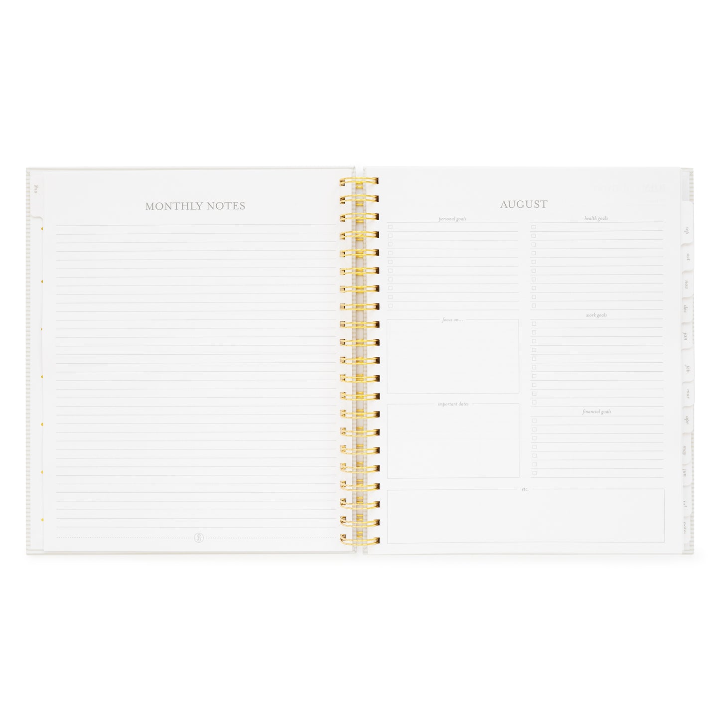 spiral planner open to monthly notes and goal setting pages