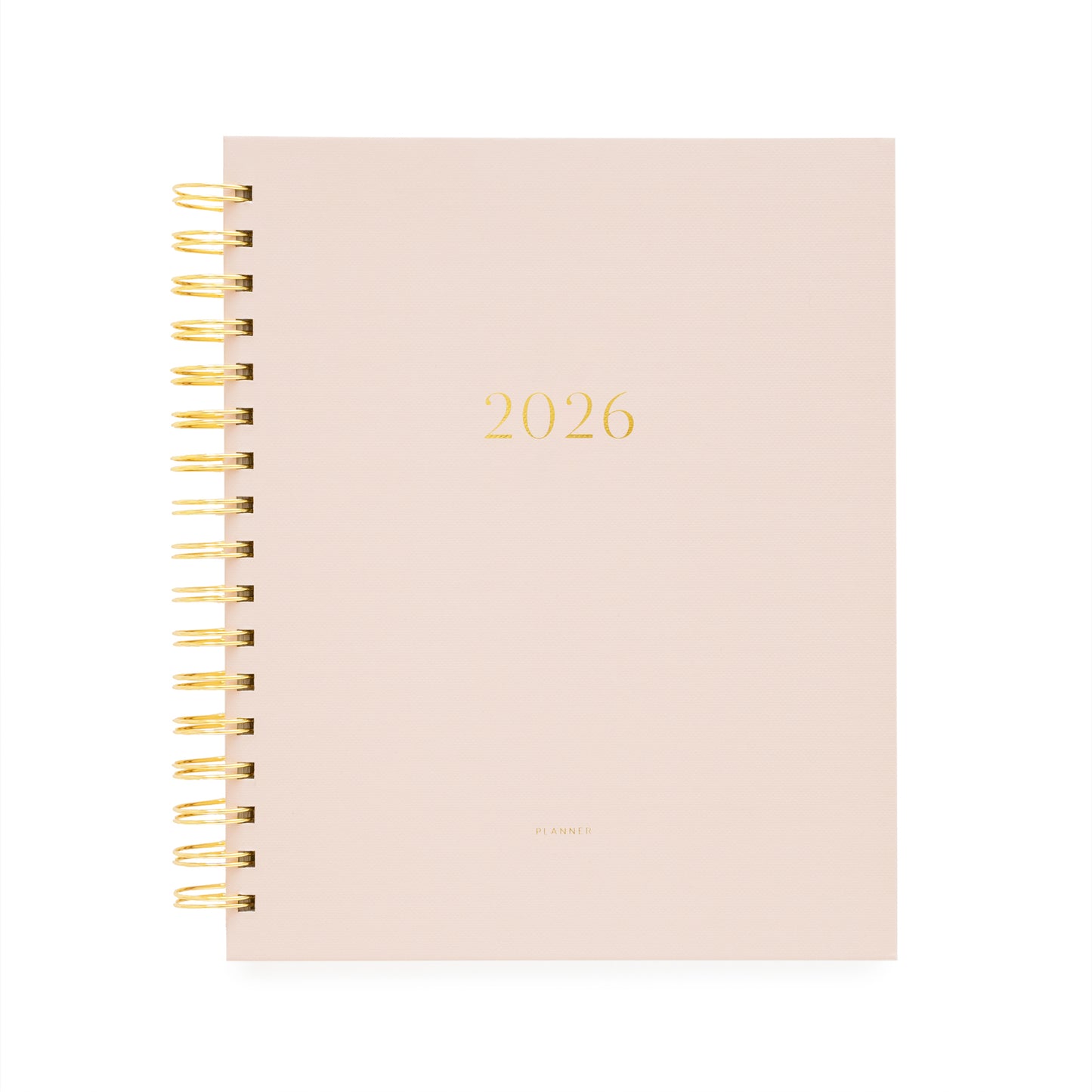 Blush pink planner with '2026' printed on it, featuring a gold spiral binding.