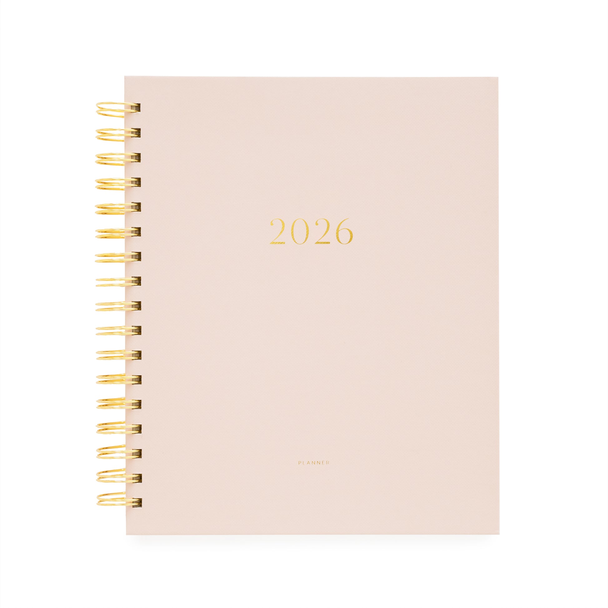 Blush pink planner with '2026' printed on it, featuring a gold spiral binding.