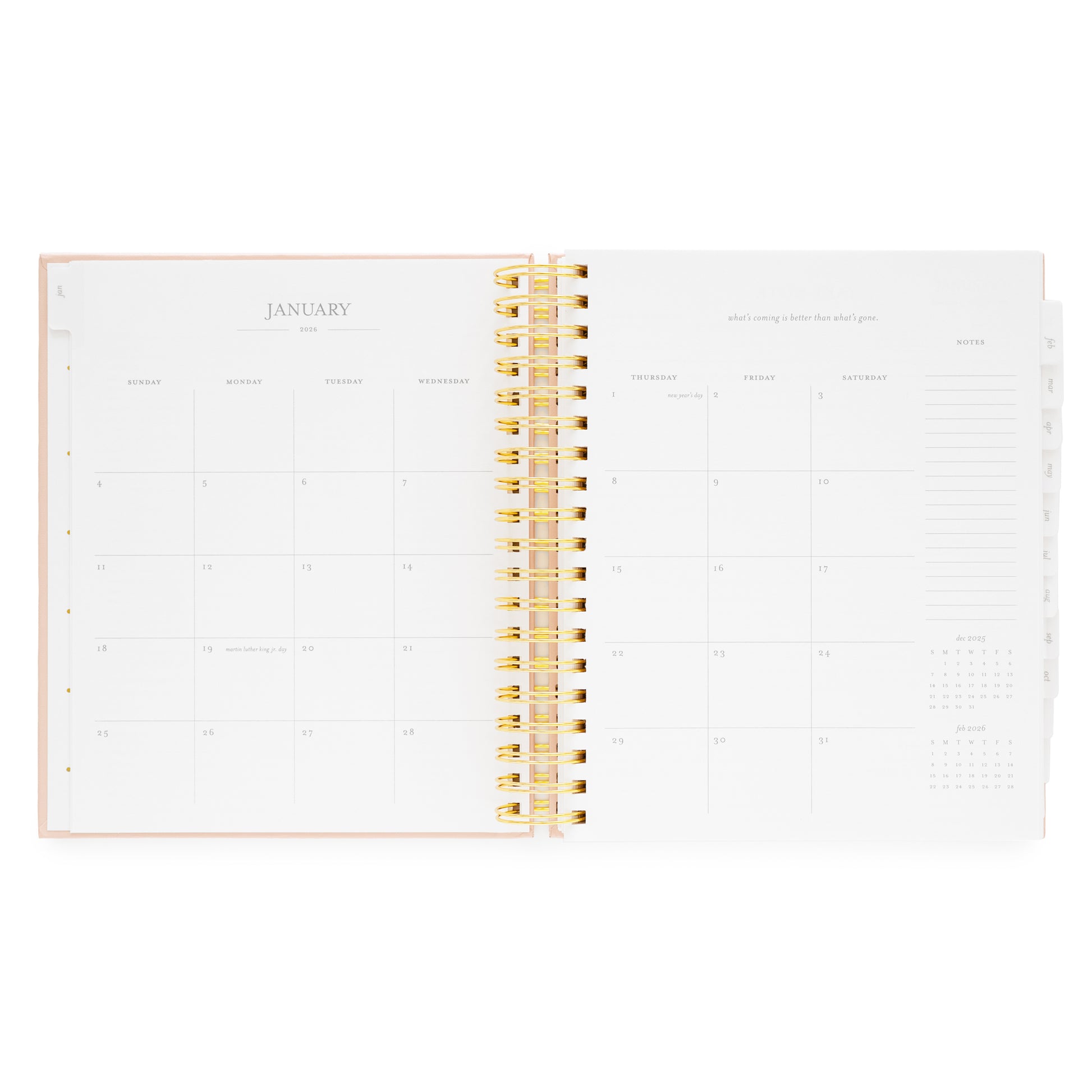 Open spiral planner showing january monthly calendar with a gold spiral binding