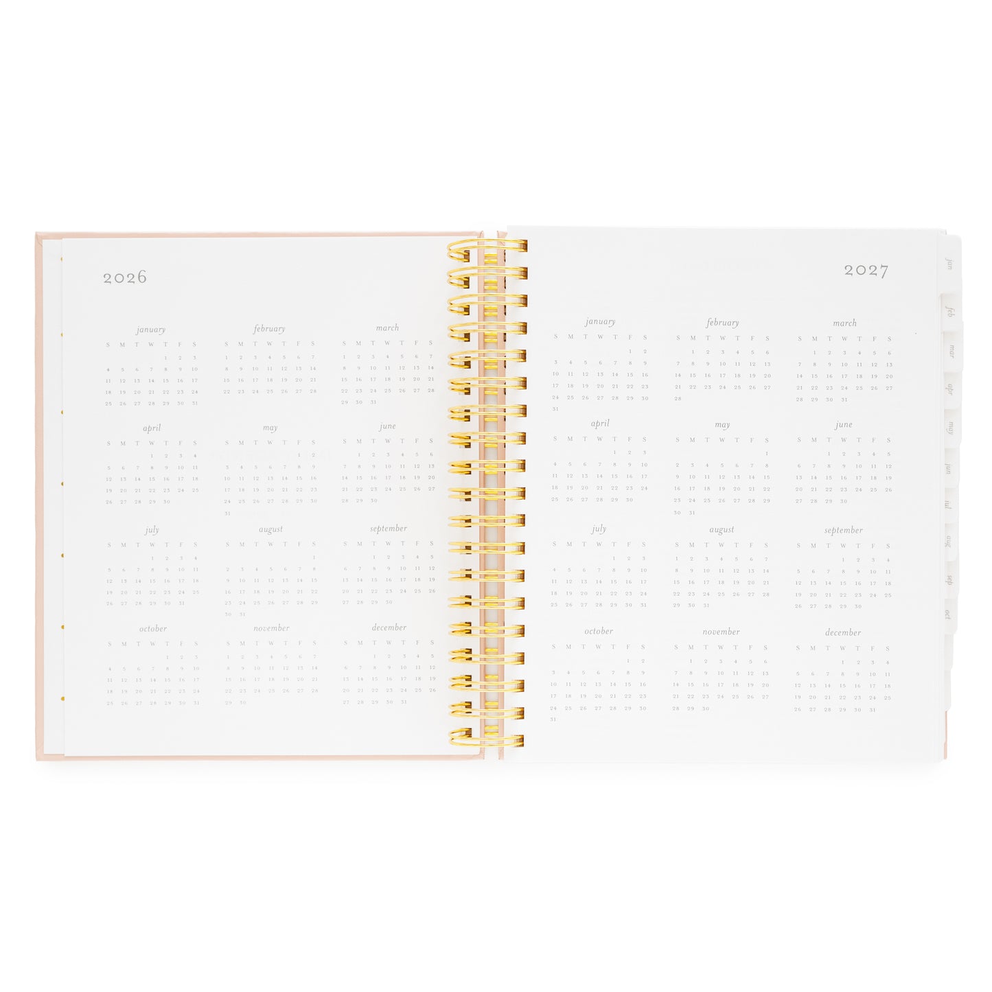 Open spiral planner with gold spiral binding and 2026 + 2027 months