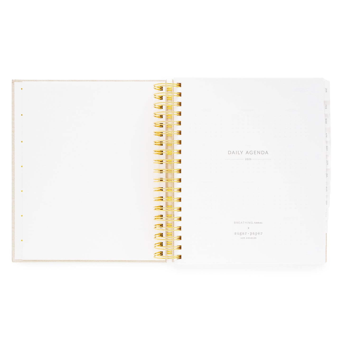 Open daily spiral planner with gold spiral binding with daily agenda 2026 and breathing room for sugar paper logo