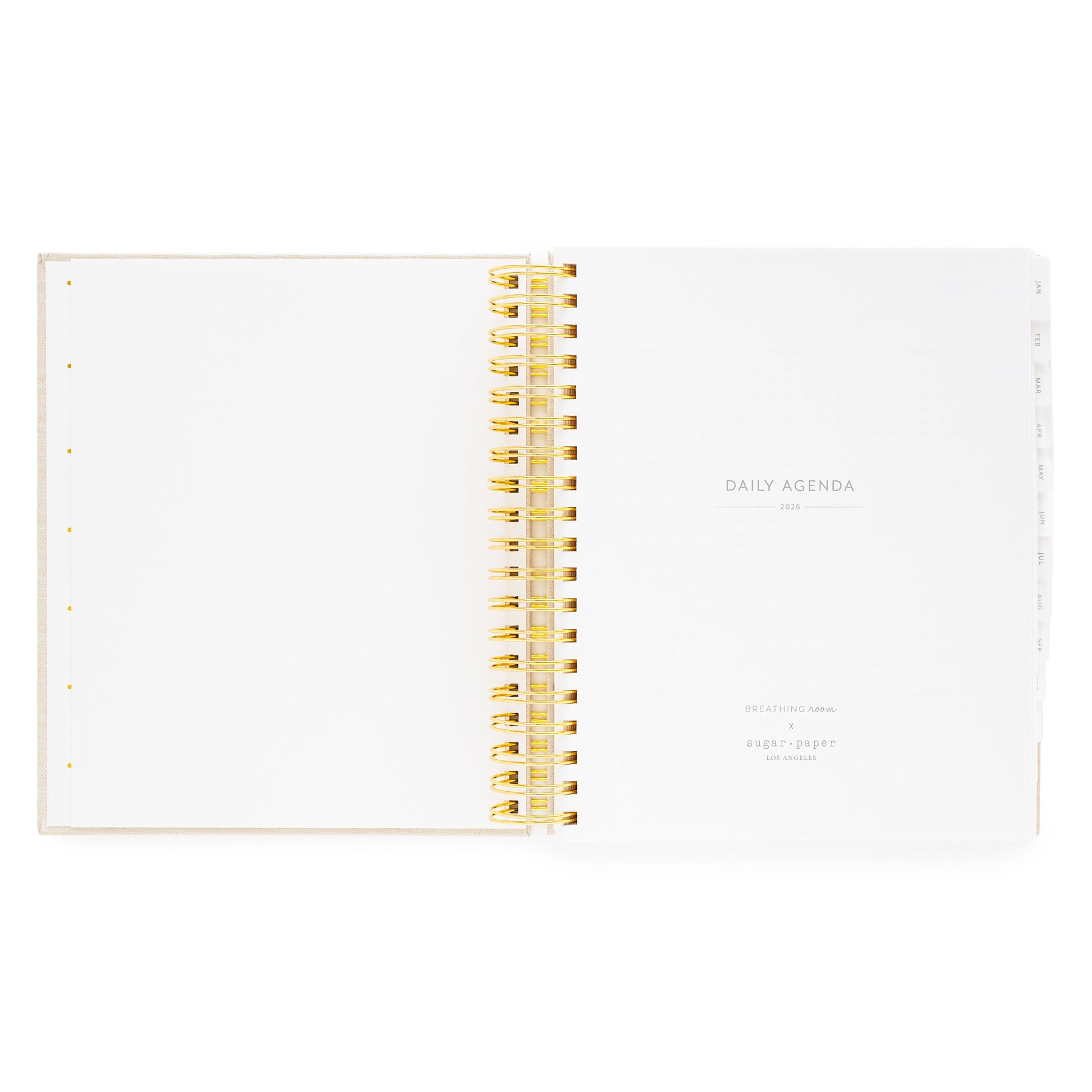 Open daily spiral planner with gold spiral binding with daily agenda 2026 and breathing room for sugar paper logo