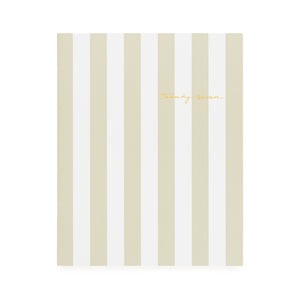 A flat monthly planner with a beige and white stripe pattern with '2027' stamped on cover in gold foil