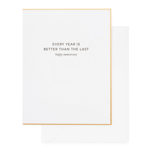 white card with black happy anniversary text and gold border, with white envelope