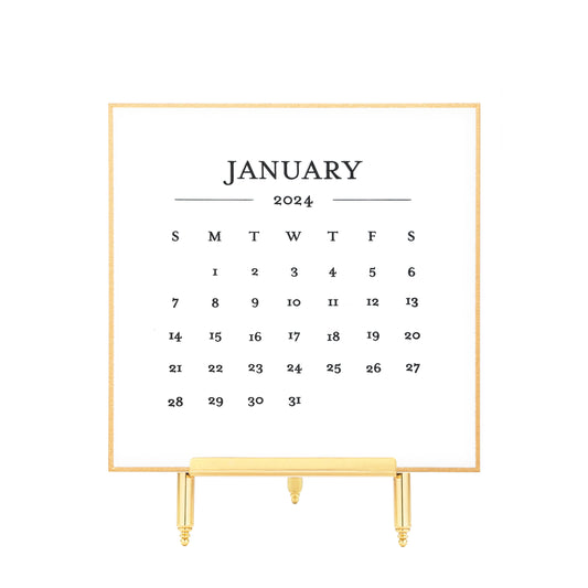 Gold bordered 2024 calendar card printed in black ink on brass stand