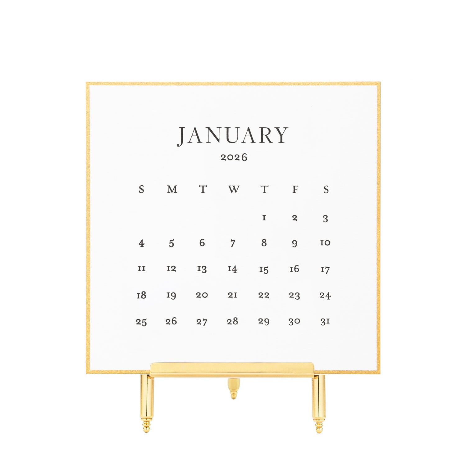 White calendar card with black letterpress ink for January 2026 on a brass stand}