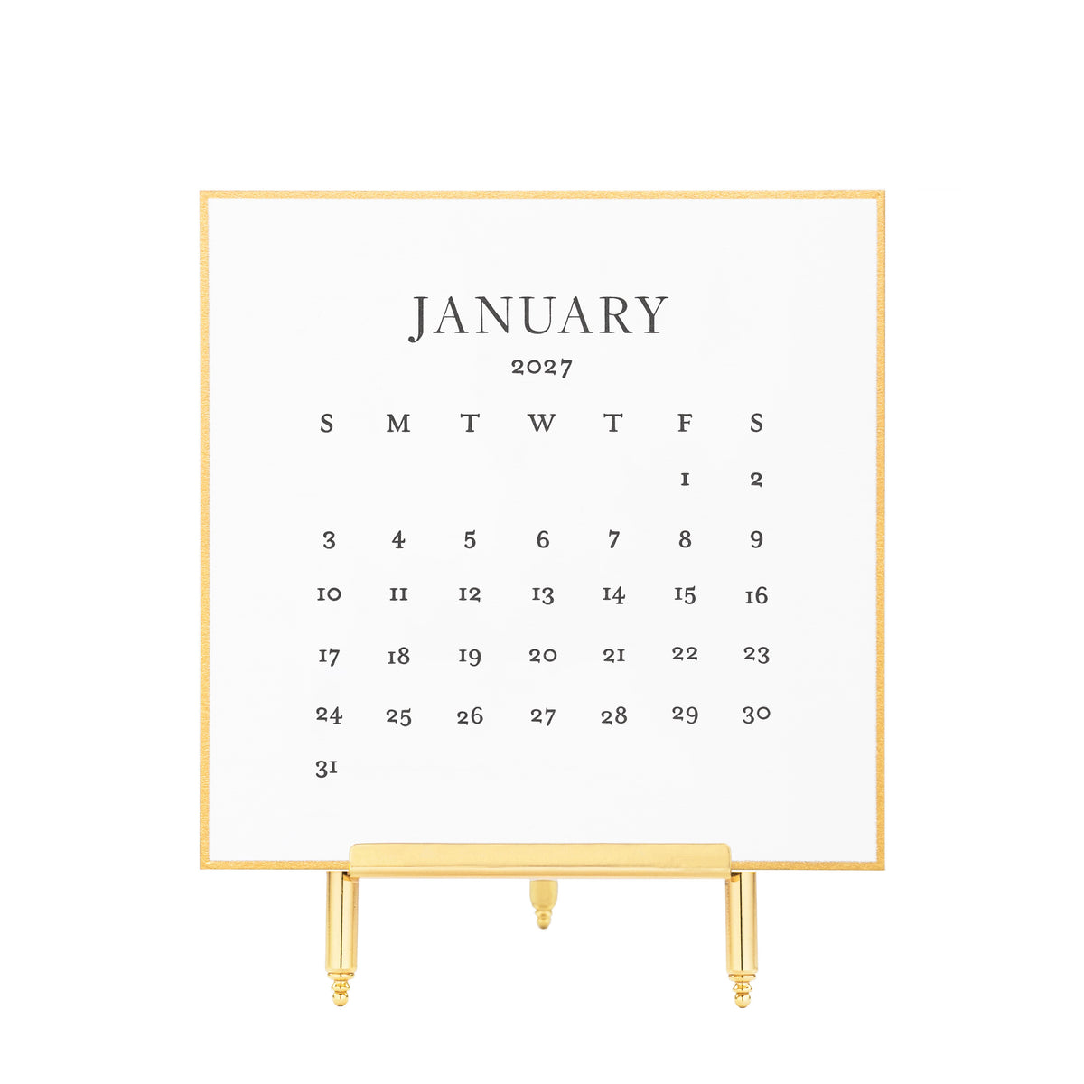 A gold hand painted bordered January 2027 desk calendar with black letterpress ink printed numbers displayed on a gold stand