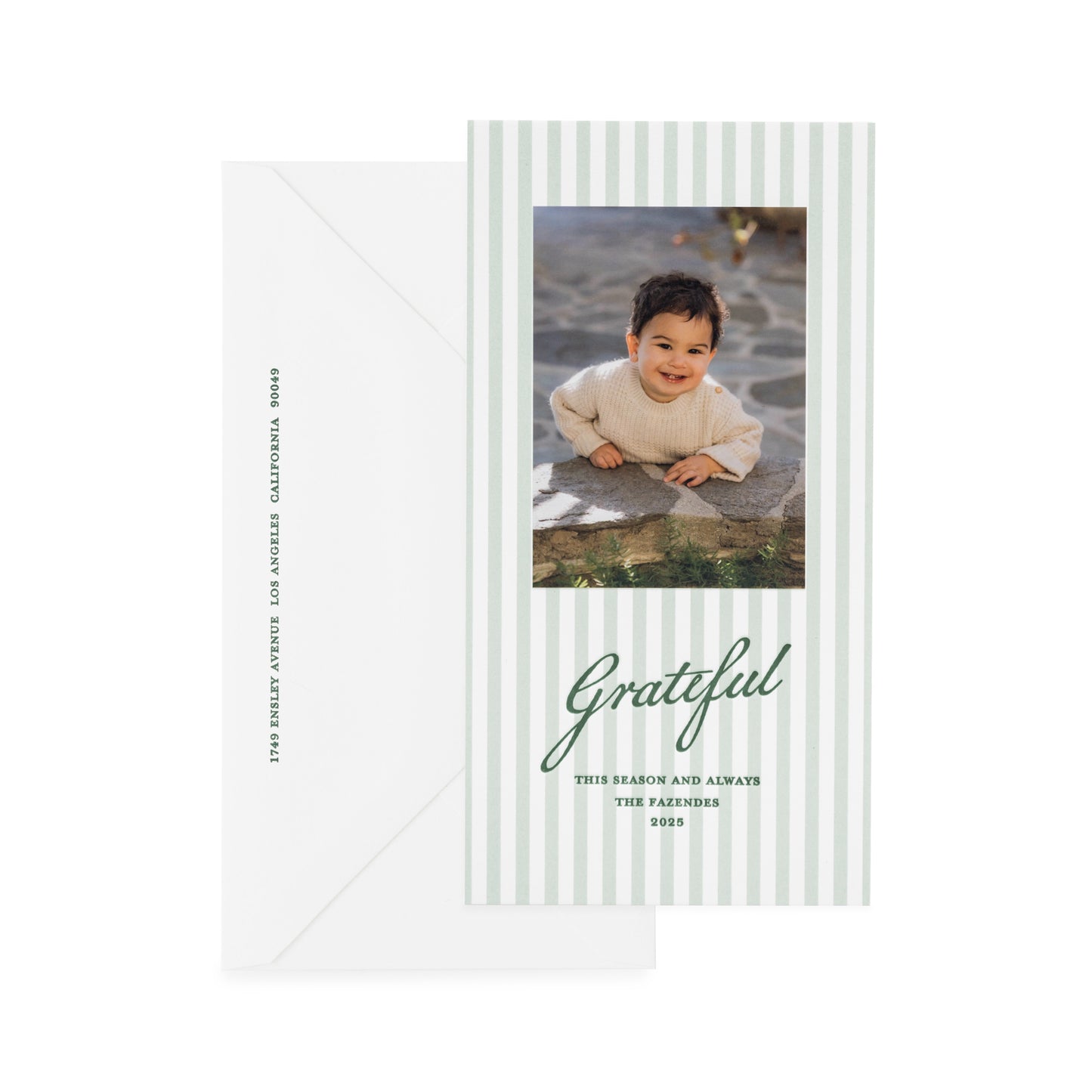 Custom holiday photo card with green stripes and green letterpress ink with 'grateful this season and always' greeting paired with a white envelope with green ink