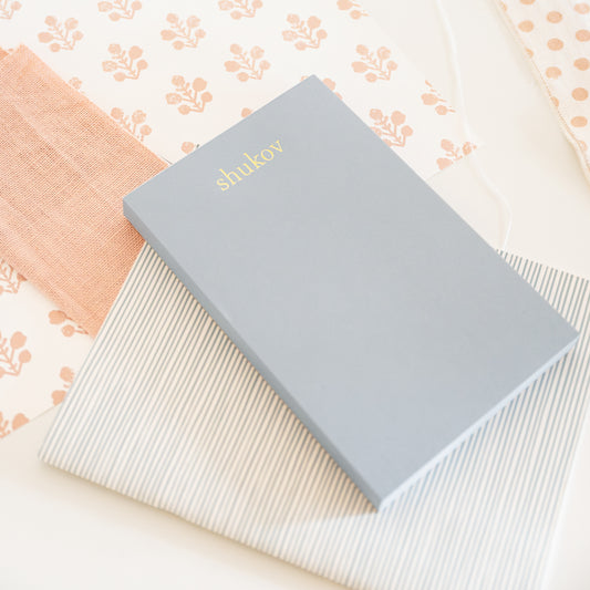 slate blue custom notepad on desk