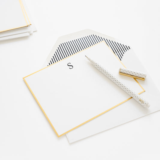 monogram note note with a black S initial, gold hand painted border and black stripe envelope liner