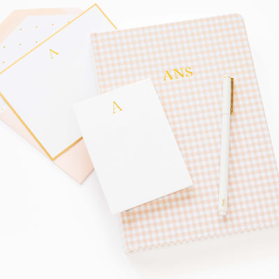 Set of checkered notebooks with gold lettering on a white background