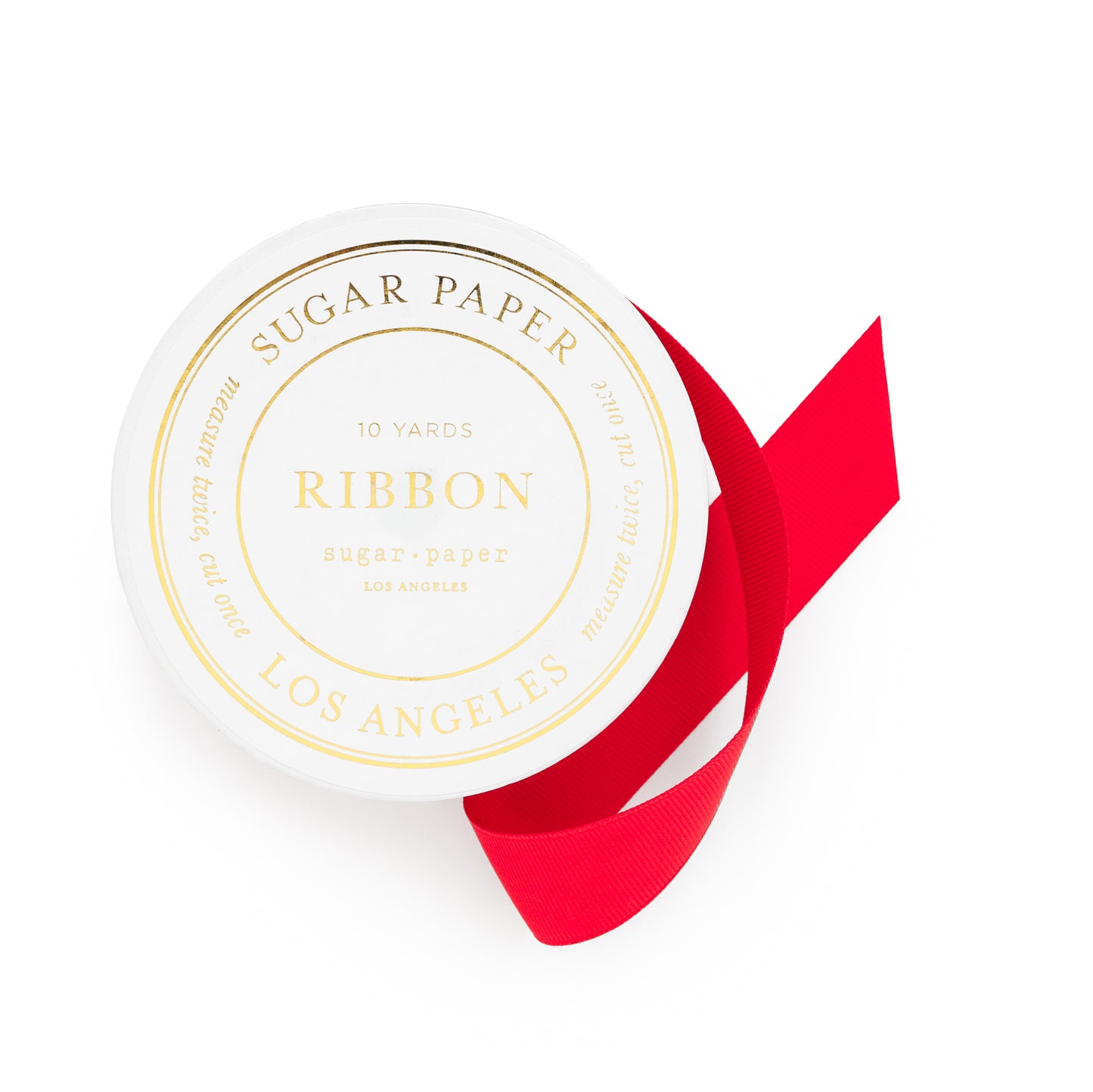 Red ribbon on white spool with gold label sticker with sugar paper 10 yards ribbon