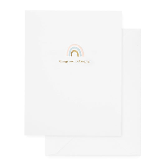 white card with pink, bliue, and gold rainbow and gold text. white envelope.