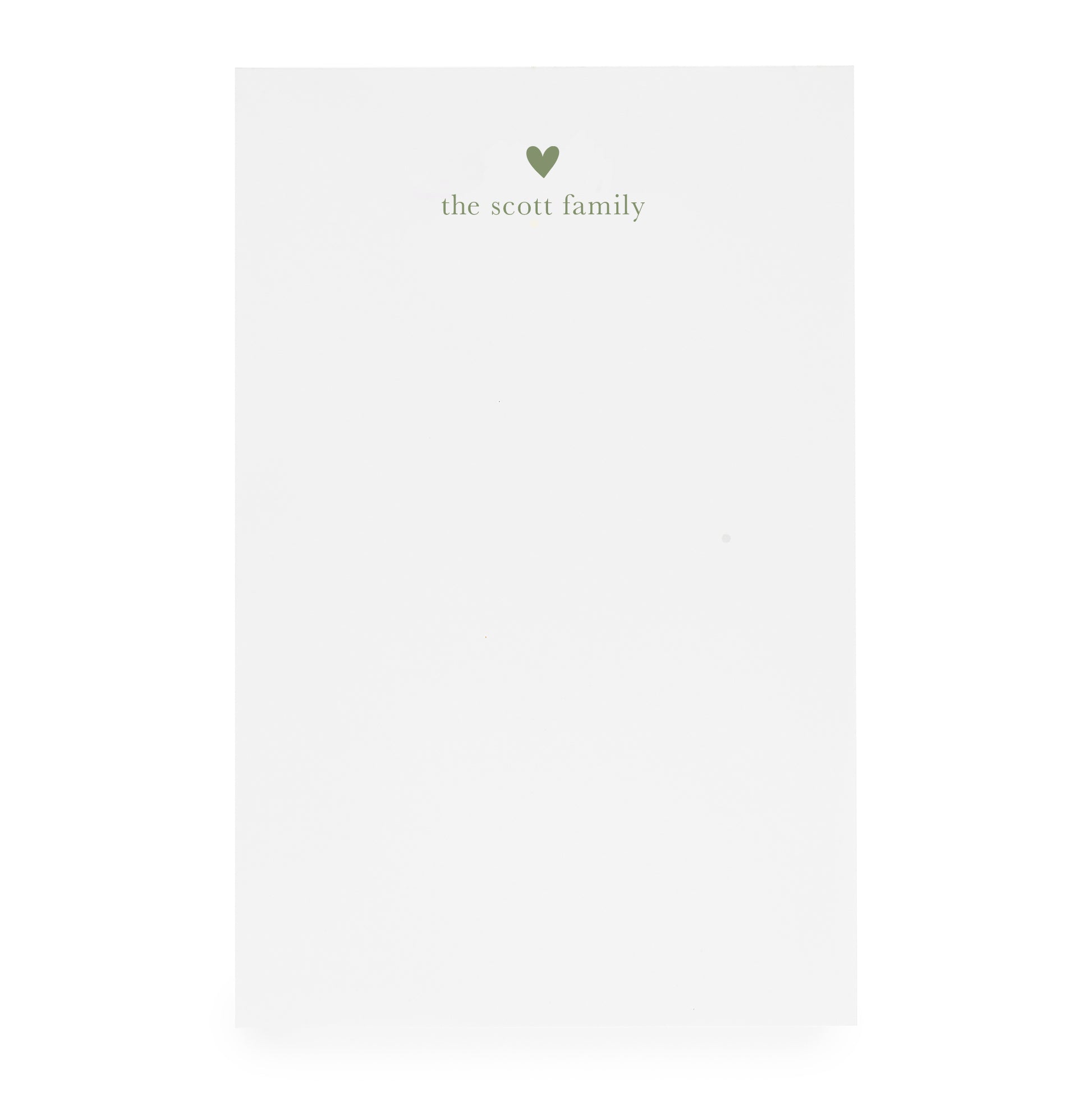 White notepad with heart and "the scott family" printed in moss green