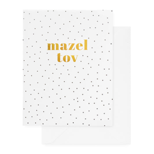 white card with gold mazel tov text and black dots, white envelope