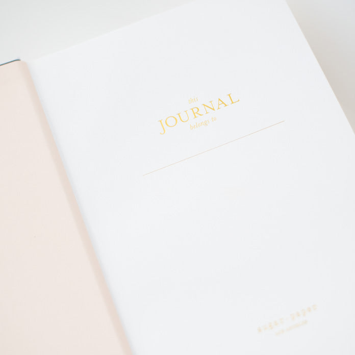 interior of journal with gold foil printed "this journal belongs to"