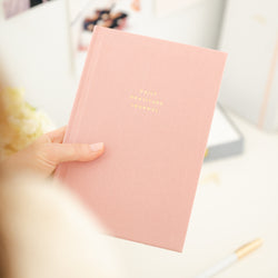 person holding rose daily gratitude journal