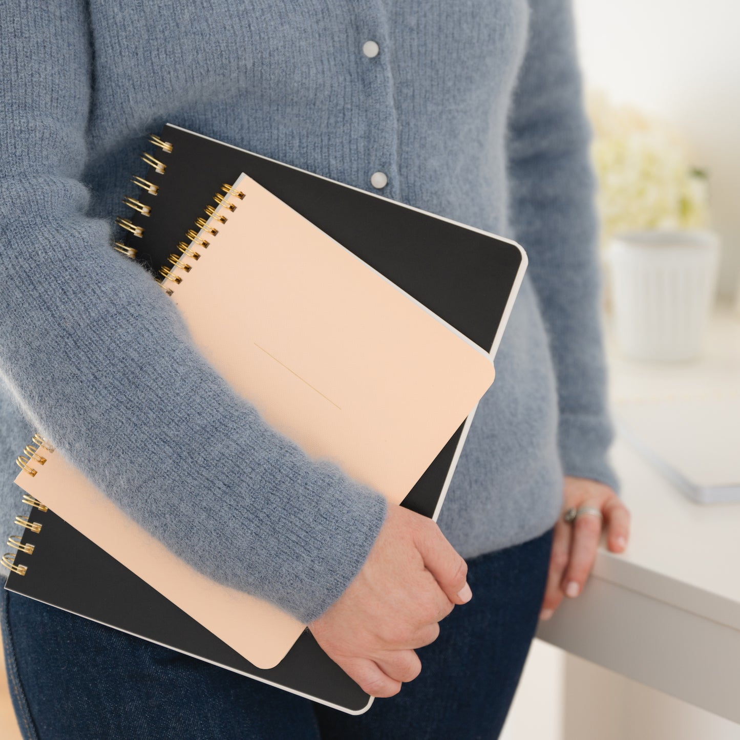 Spiral notebooks in hand