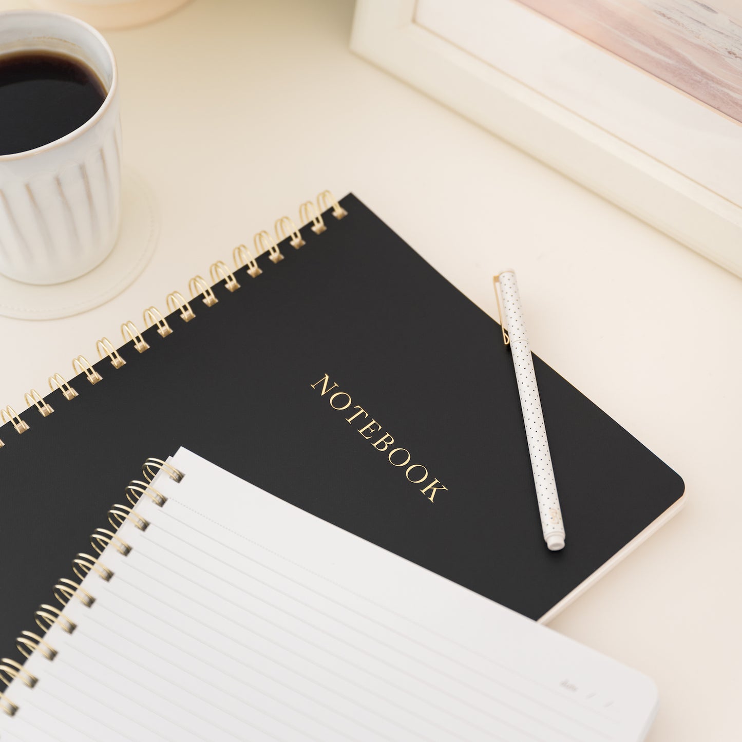Stacked notebooks on desk