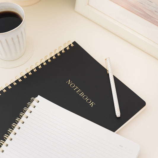 Stacked notebooks on desk