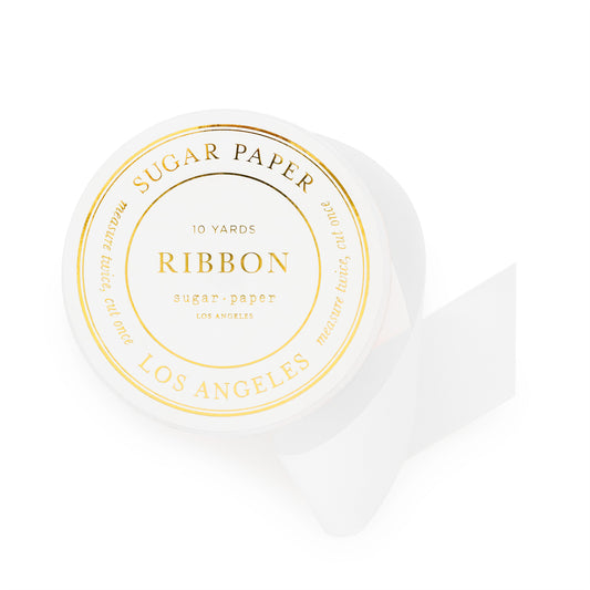 spool of white ribbon with gold foil details