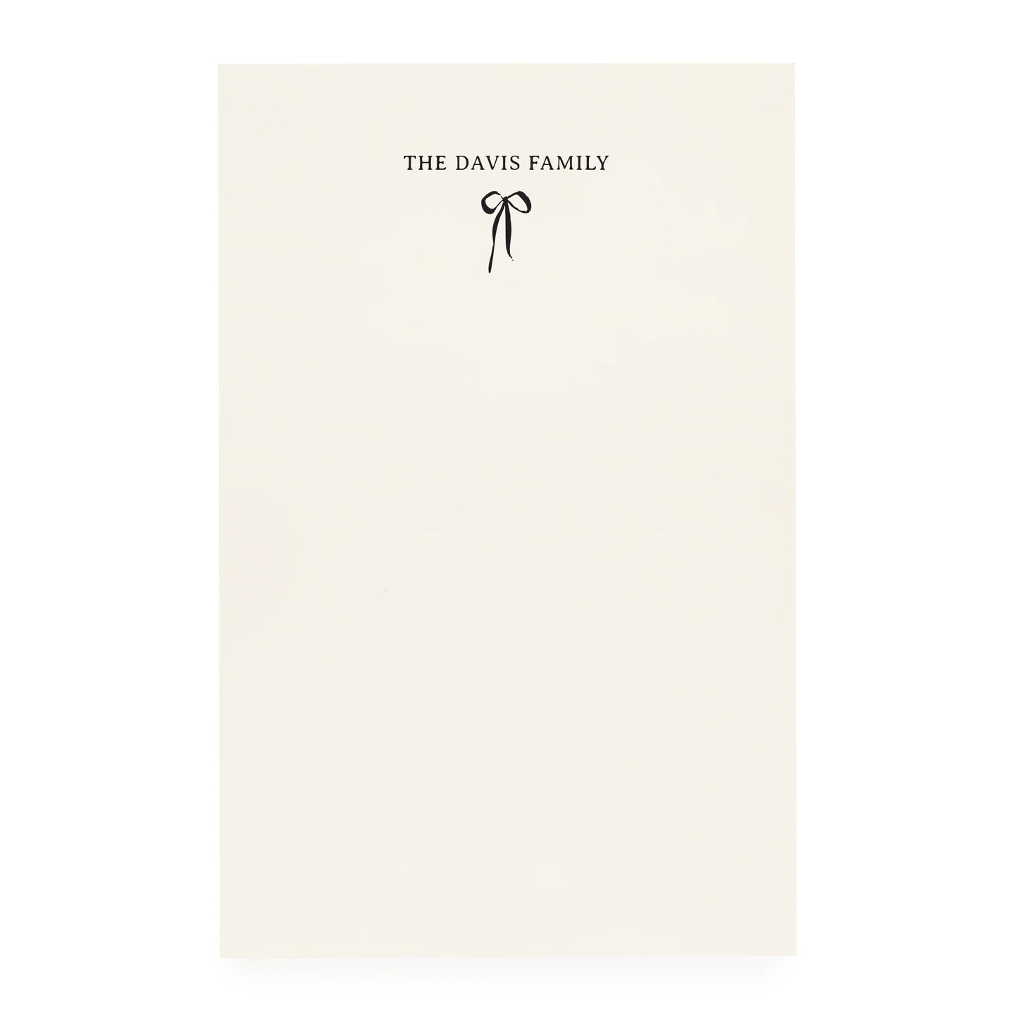 Cream notepad with a black bow and "the davis family" printed