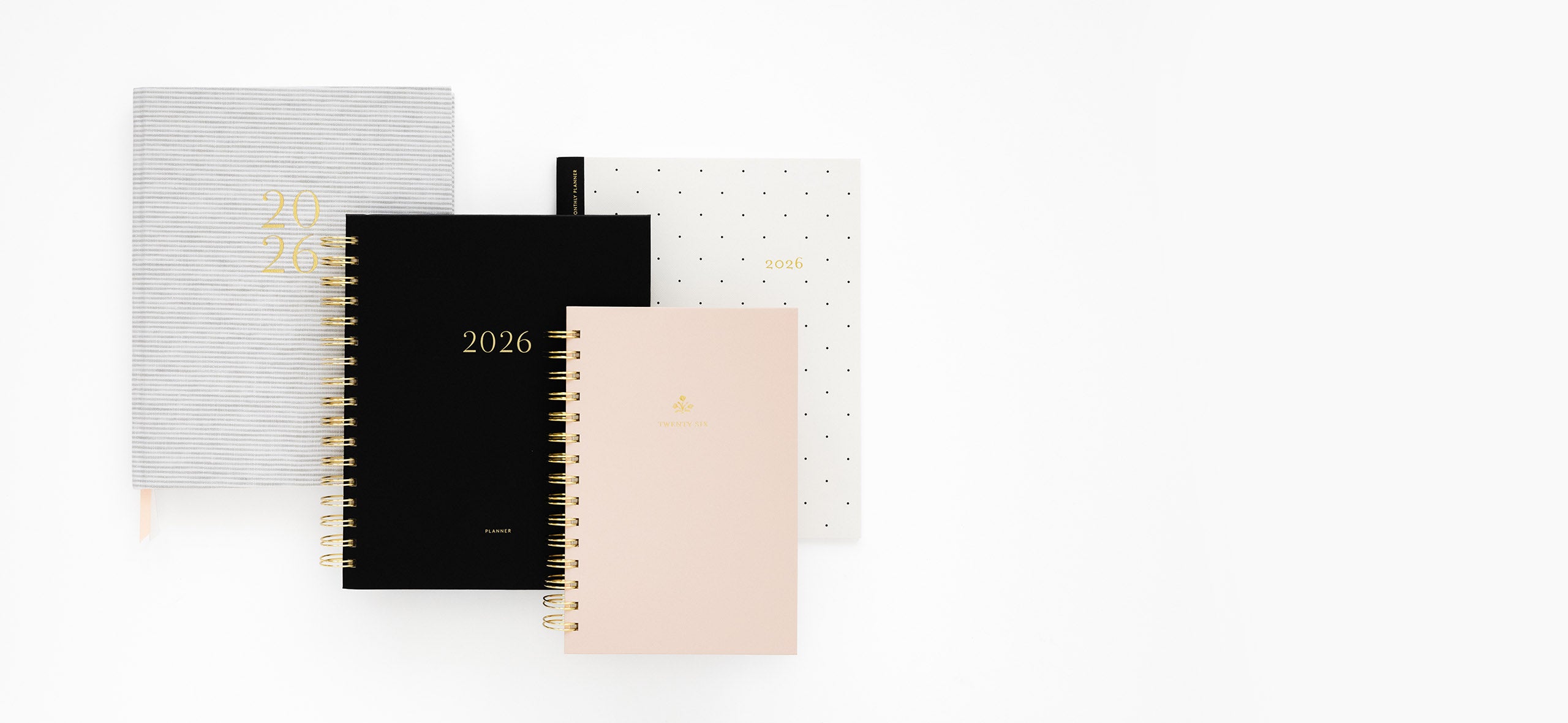 Four 2026 planners in grey stripe, black, pink, black dot styles