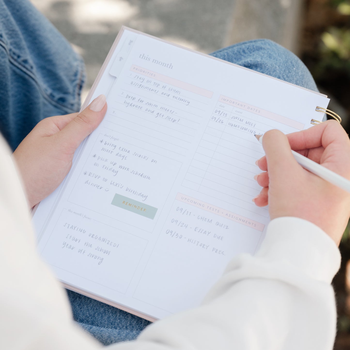 student planner interior with stickers and writing open to important dates, tests, and priorities