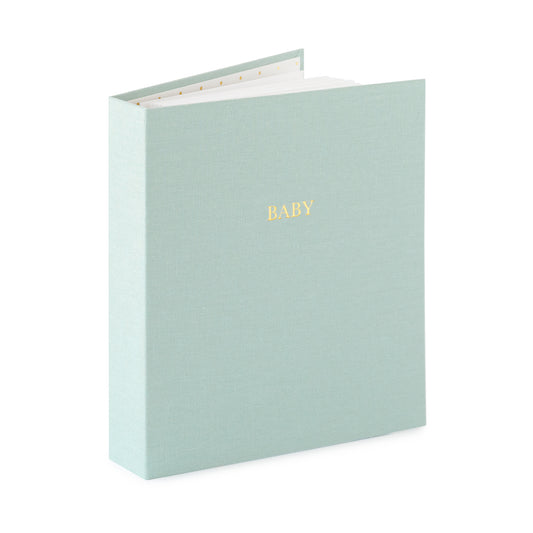 misty green fabric baby book book open standing up foil stamped with baby in gold on the cover