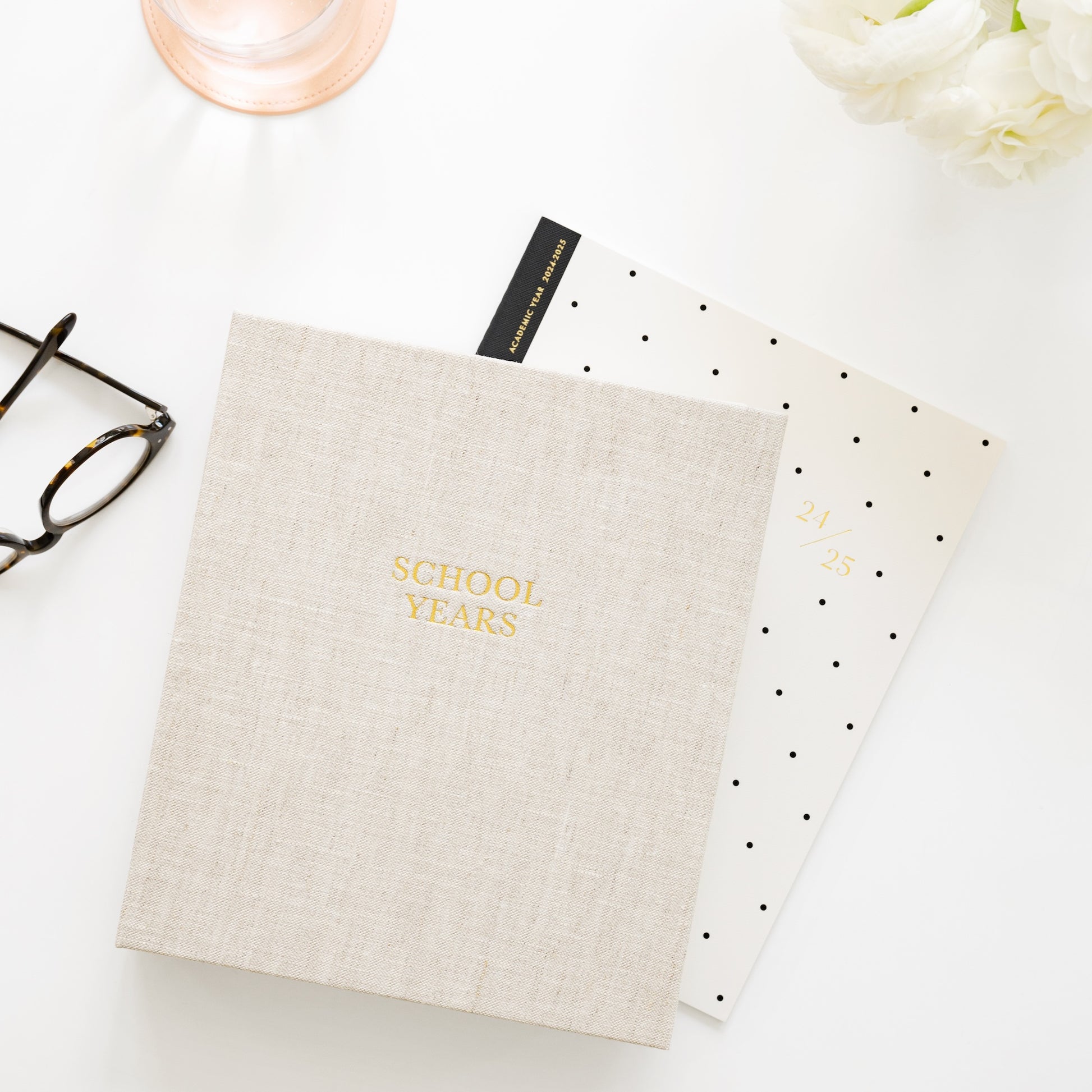 Flax linen school years book on desk with planner and glasses