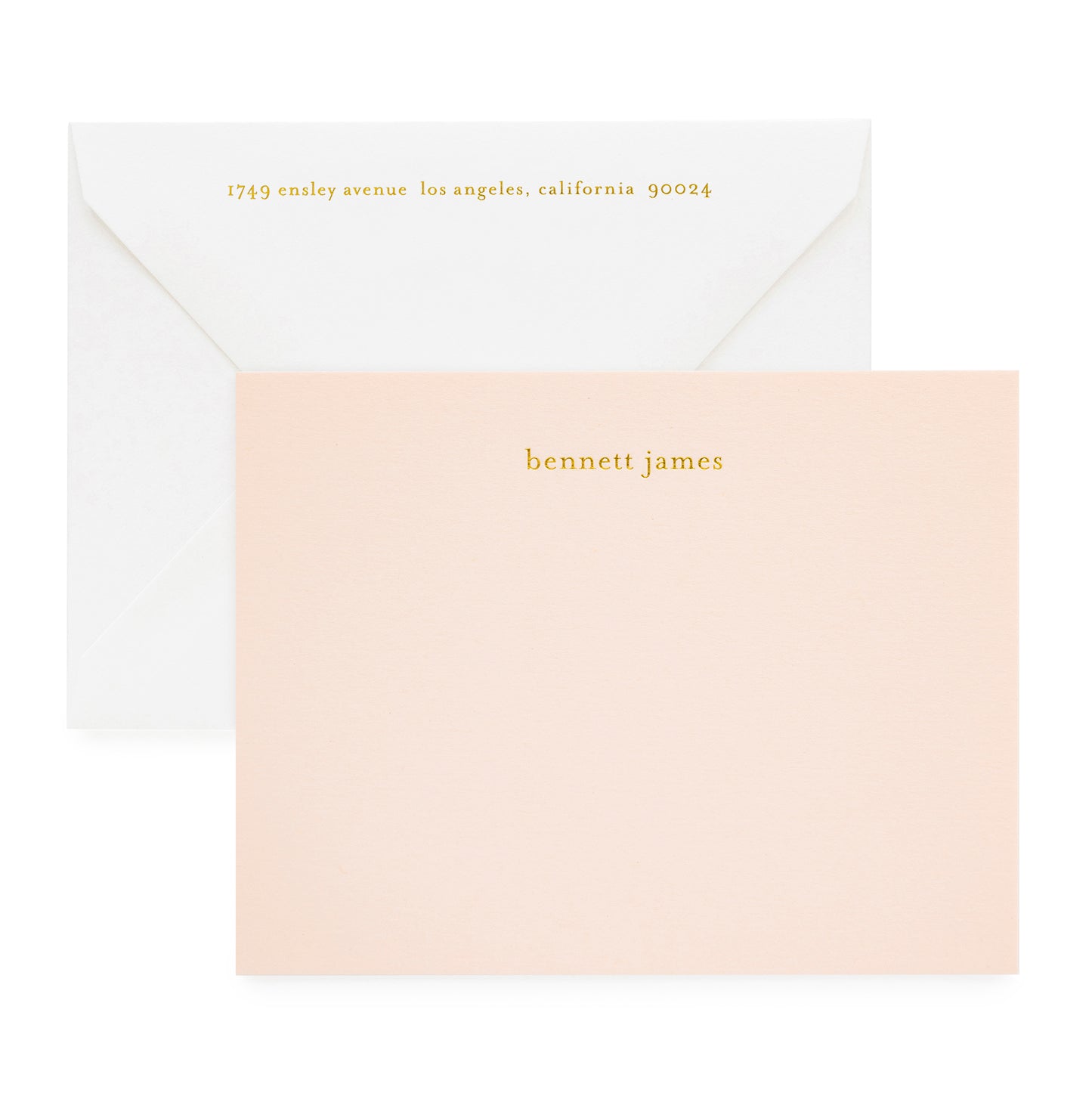 Pale pink custom stationery printed with gold foil paired with a white envelope