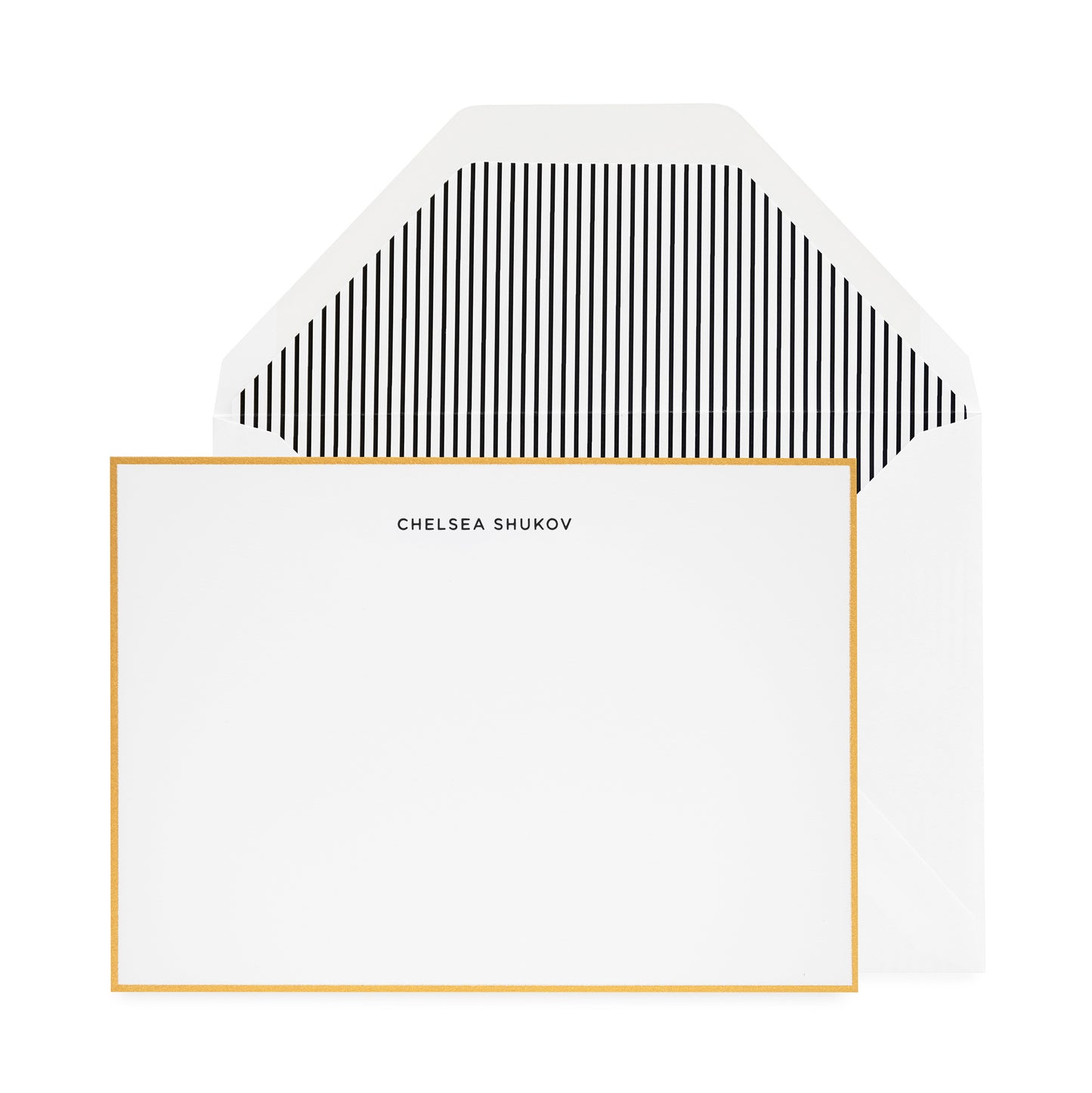 Black letterpress printed chelsea shukov stationery with a gold border and black stripe liner