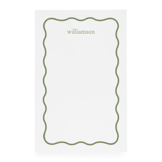 White notepad with green scallop border and 'williamson' in green ink