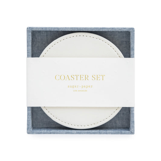 White coasters in chambray fabric holder