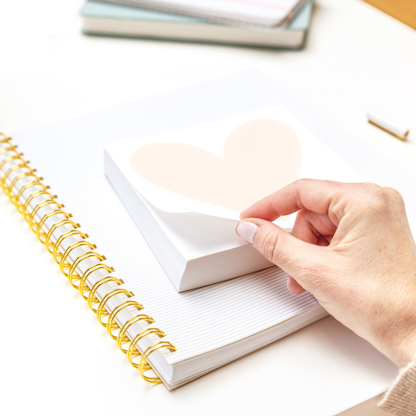 person flipping through heart deskpad