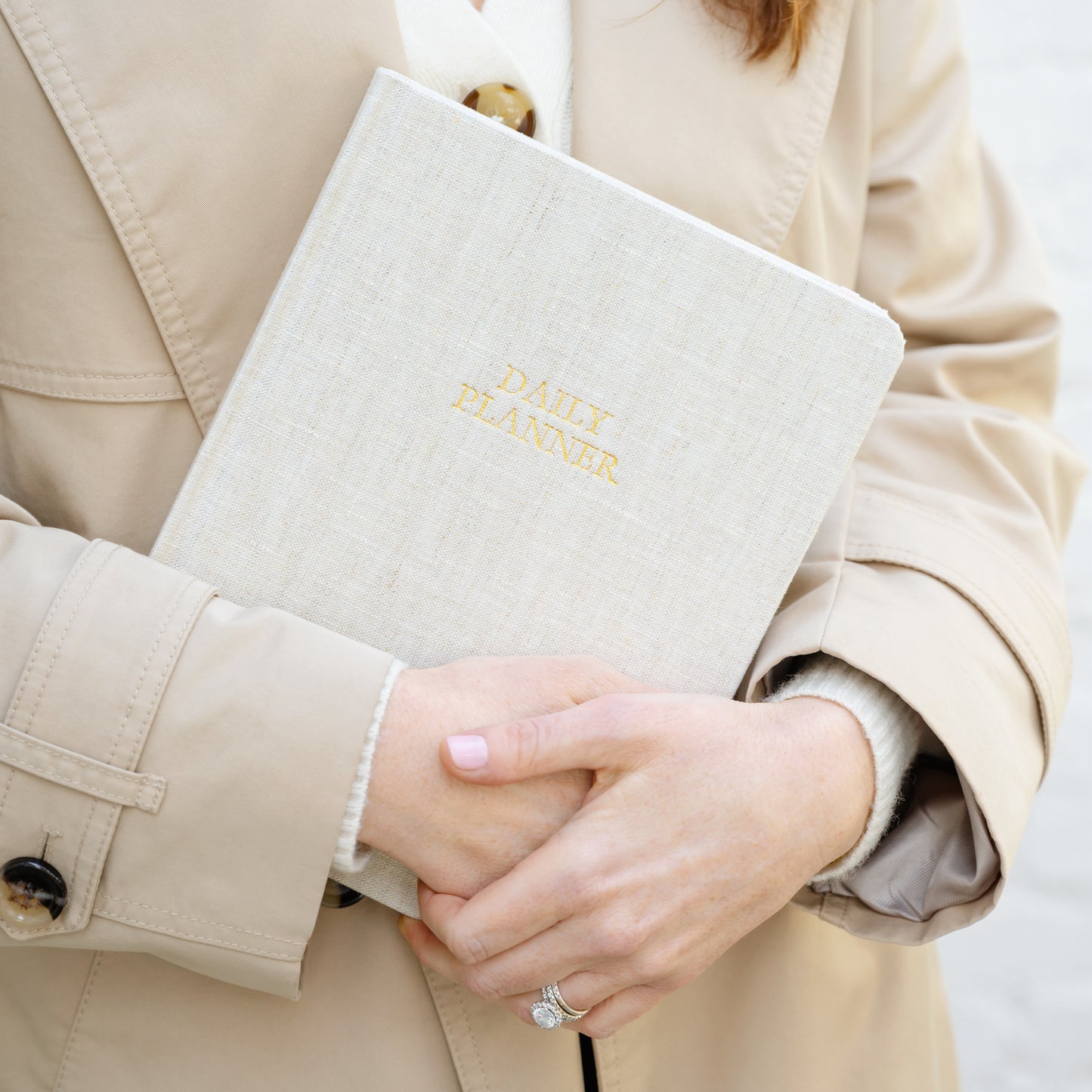 Flax fabric daily planner in hands with foil stamped daily planner on cover