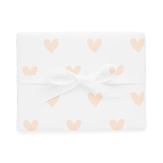 pink heart gift wrap shown tied with a white ribbon