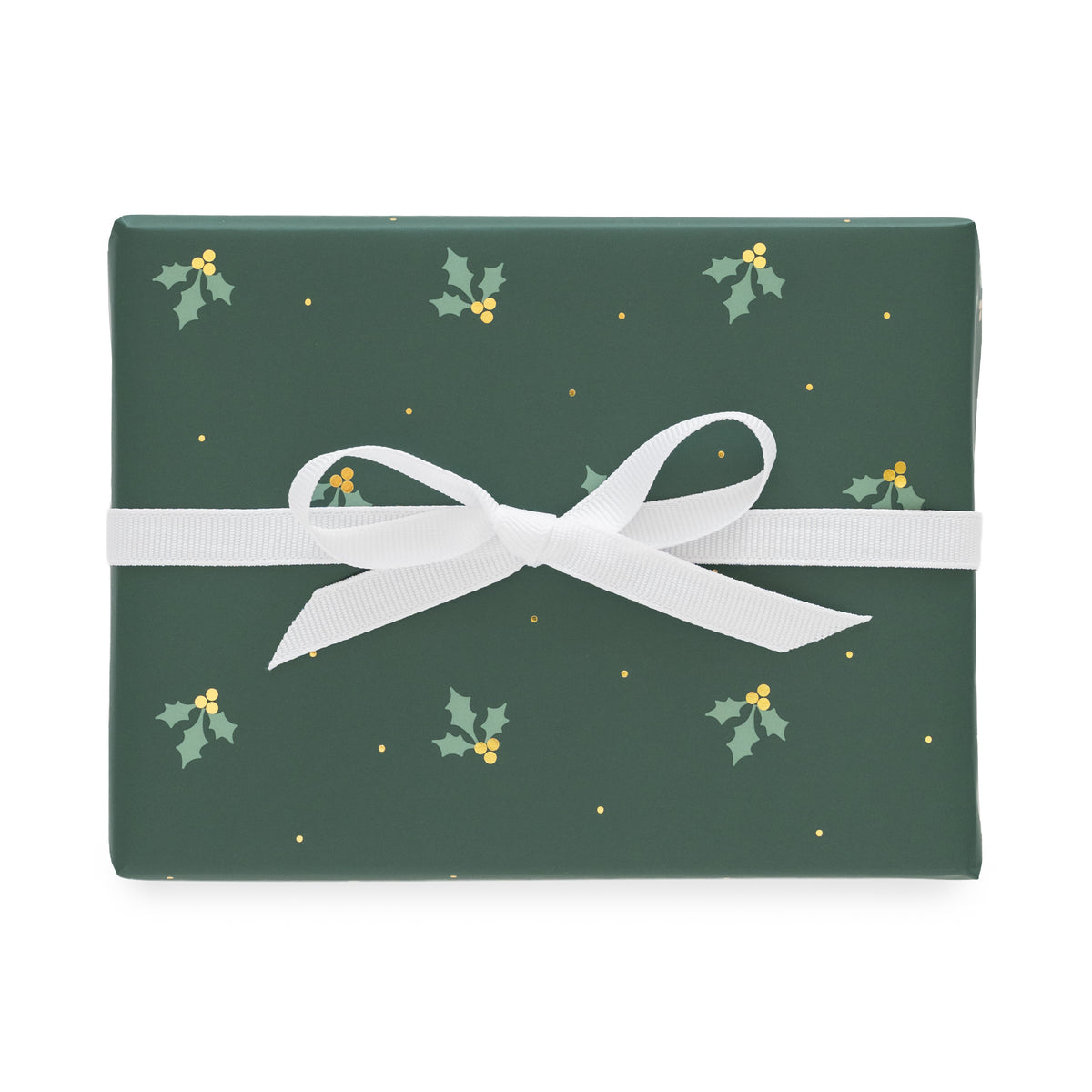 A rectangular gift box wrapped in dark green holiday paper with a white ribbon bow, featuring a pattern of small holly leaves, gold berries, and gold dots