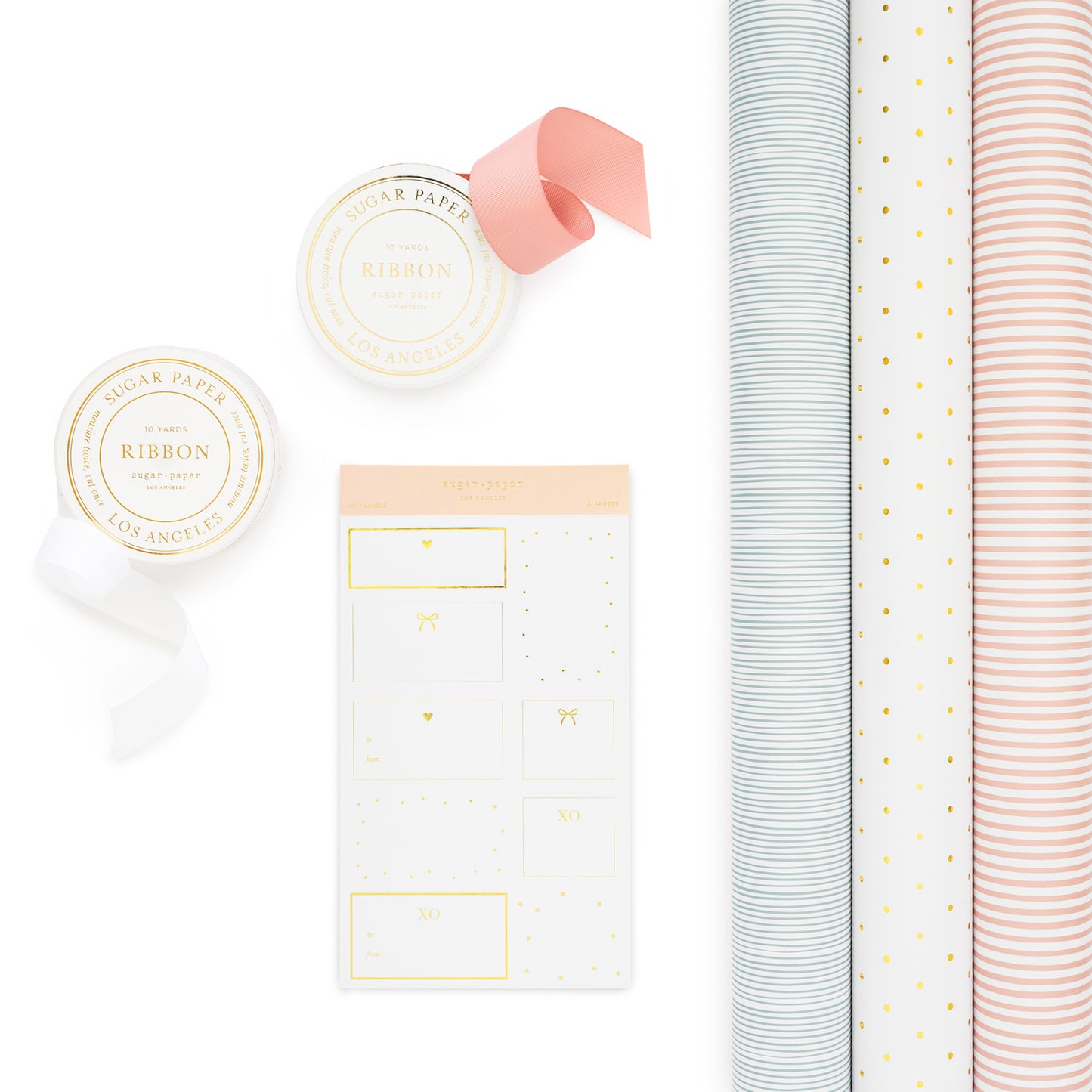 gift wrap set with 3 wrapping rolls - blue stripe, gold dot, and pink stripe paired with pink and white ribbon and gold and white gift stickers