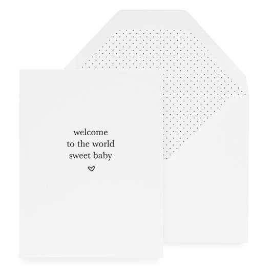 White greeting card printed with welcome to the world sweet baby