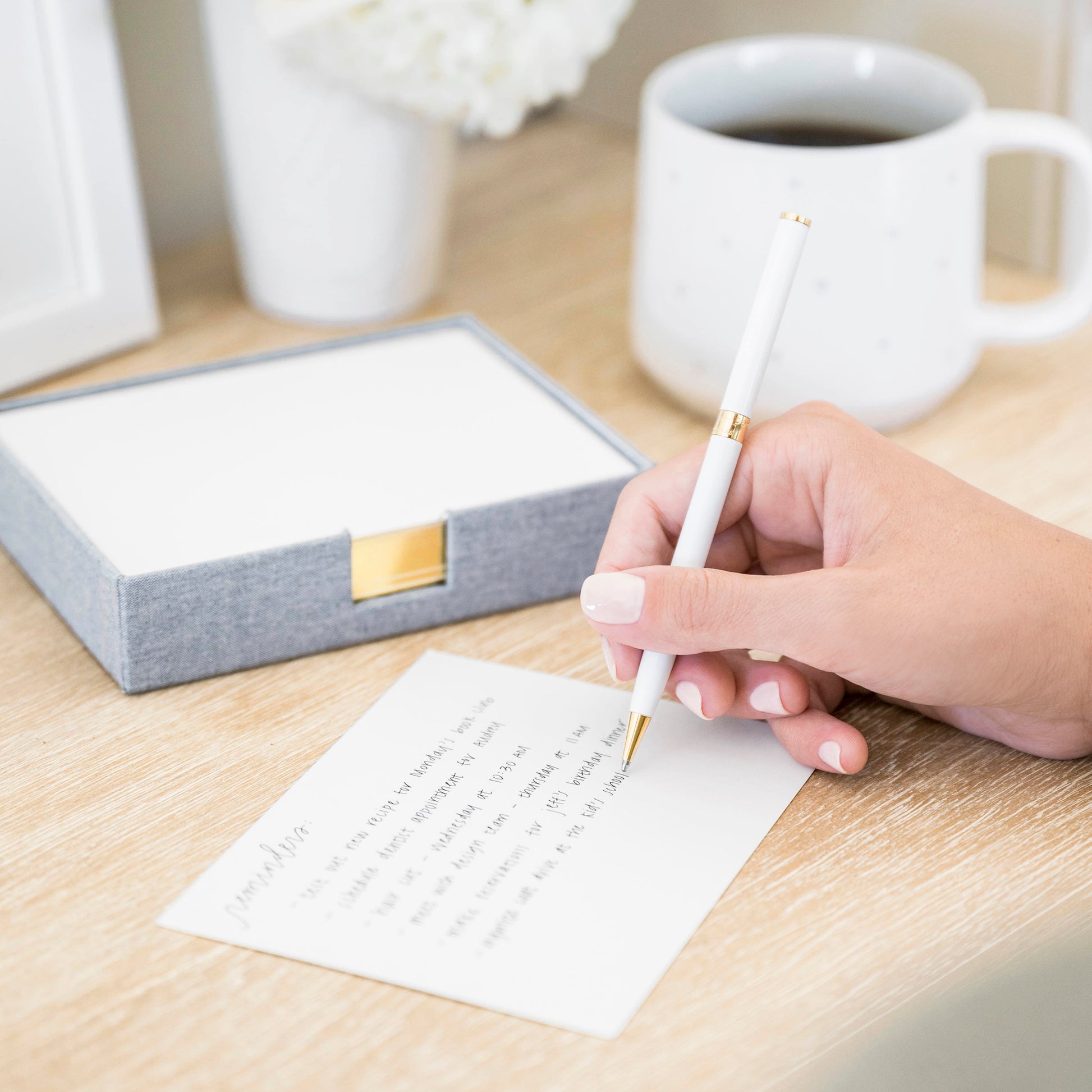 Desk jotter on desk scene with woman writing on note cards