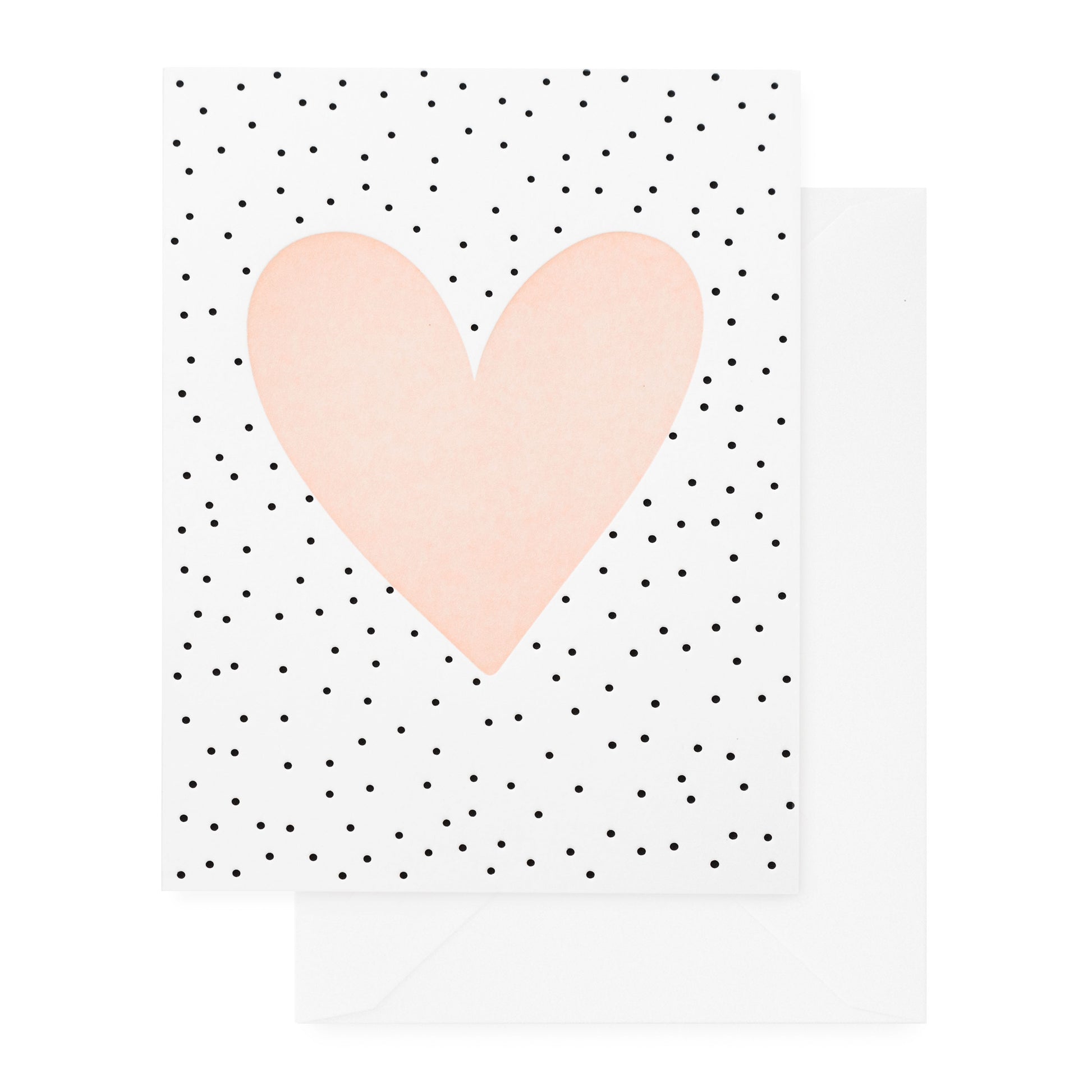 white card with black scattered dots and pale pink heart, white envelope