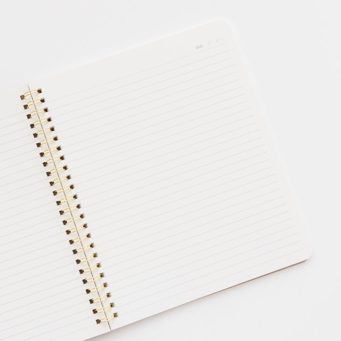 open spiral notebook showing lined pages