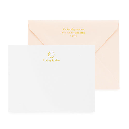 white card with gold foil smiley and text, pale pink envelope