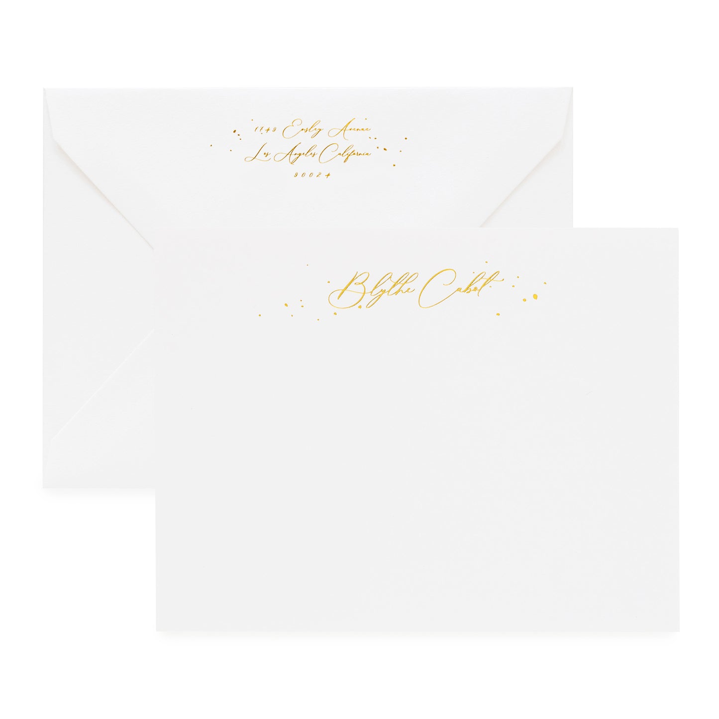 White stationery set with gold foil script name and gold return address detail