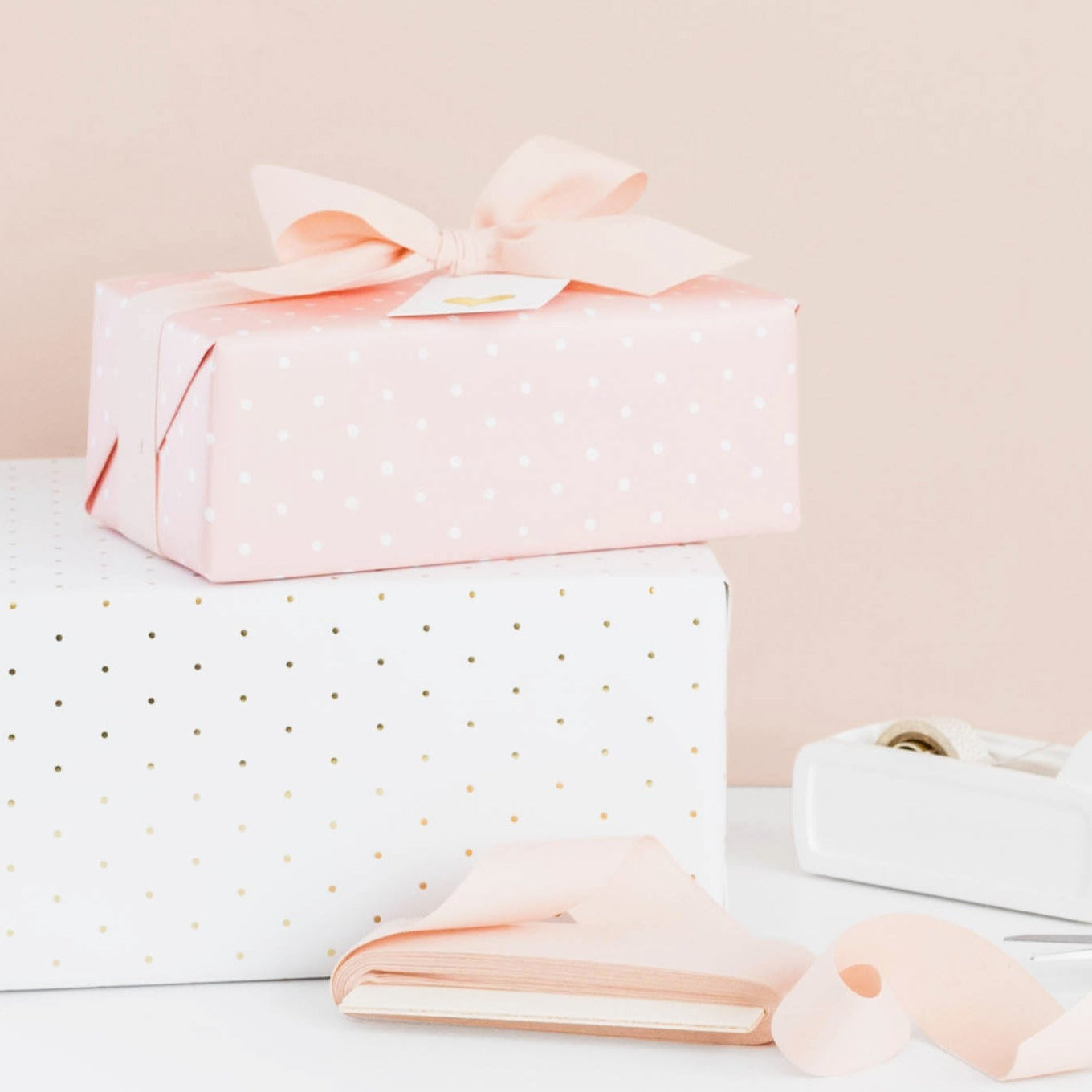 Stacked wrapped gifts with ribbon and tape
