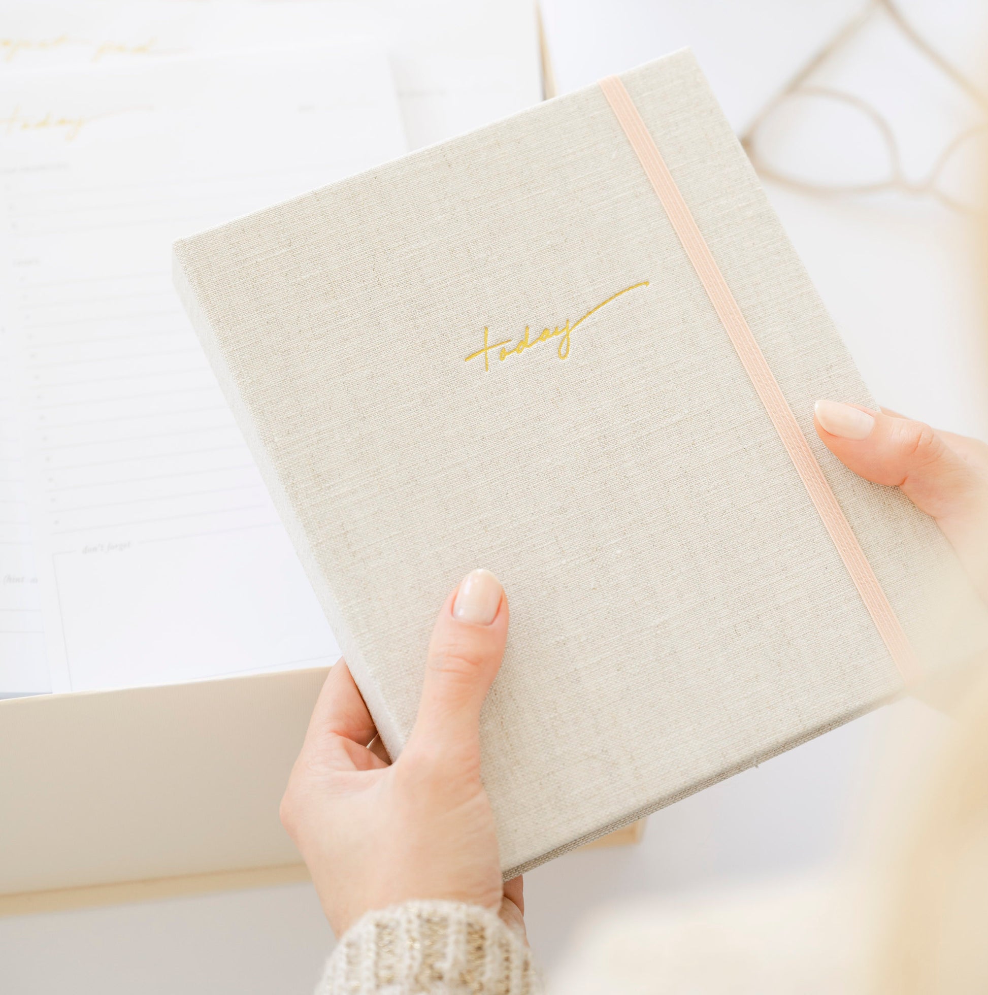 hands holding flax mindful journal with gold foil today on cover