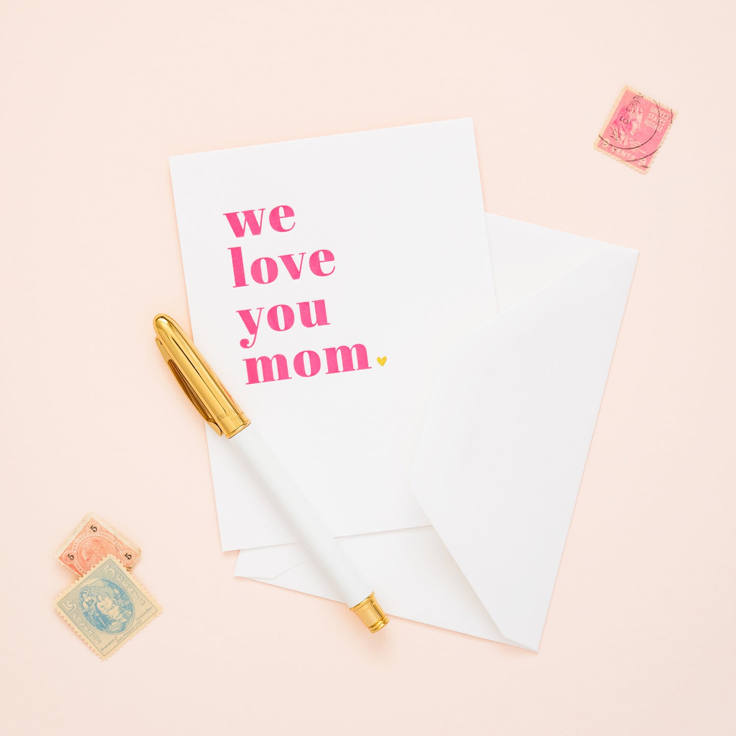 we love you mom card on desk with pen and stamps